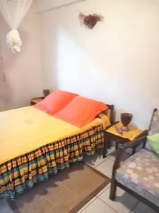 a bedroom with a bed and a chair at Studio accueillant à Sainte-Luce, 30 m² avec jardin privé in Sainte-Luce