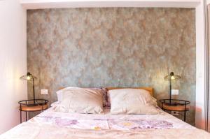 a bedroom with a bed with two side tables at Cozy apartment in Playa de la Américas, 60 m² with pool in Playa de las Americas +4 photos