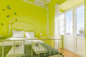 a bedroom with a bed with a green wall at Alfama Santa Apolonia Apartment in Lisbon