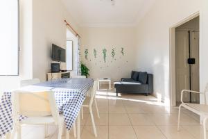a living room with a table and a couch at Alfama Santa Apolonia Apartment in Lisbon