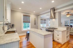 a large kitchen with white counters and a stove top oven at Historic Lady Renovated-Half Mile Walk to DT-Beach 3 Mi-Optional Guesthouse in Saint Augustine