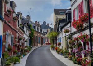 an empty street with flowers on the sides of buildings at Le Quai 2 Somme in Abbeville