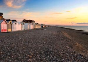 a row of beach huts on the beach at sunset at Le Quai 2 Somme in Abbeville +5 photos