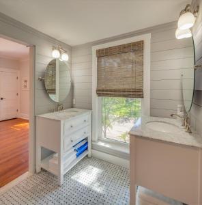 a bathroom with two sinks and a large window at Historic Lady Renovated-Half Mile Walk to DT-Beach 3 Mi-Optional Guesthouse in Saint Augustine +36 photos