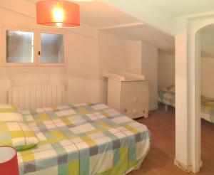 sypialnia z łóżkiem z kocem w kratę w obiekcie Villa charmante avec piscine privée à Montferrat - 125 m² w mieście Montferrat