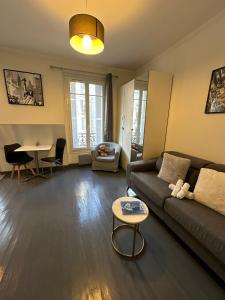 a living room with a couch and a table at Cosy studio Beaubourg paris centre in Paris