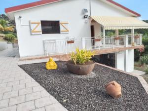 a house with a porch and a patio at Appartement cosy à La Trinité, 20 m², avec jardinlo in La Trinité