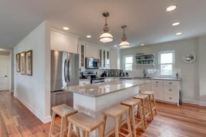 a kitchen with a large island with bar stools at Cottage One Gorgeous Ocean View From 60 foot Deck in Saint Augustine Beach