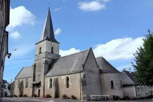 an old church with a clock tower on a street at Chaleureuse Maison de Campagne avec Terrasse et Cheminée in Lignières-de-Touraine