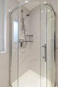 a shower with a glass door in a bathroom at Quay Escape - Short Stays UK Ltd in Exeter +37 photos