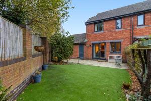 a garden in a brick house with a lawn at Quay Escape - Short Stays UK Ltd in Exeter