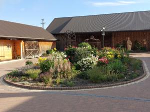 a garden of flowers in front of a building at Villa Padiego in Alojzów +10 photos