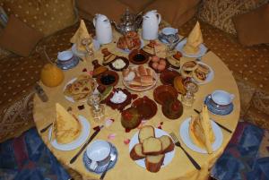 a table with plates of food on top of it at Riad Villa Midelt in Midelt