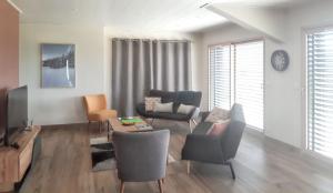 a living room with a couch and a table and chairs at Maison spacieuse à Cerniébaud avec magnifique jardin. in Cerniébaud