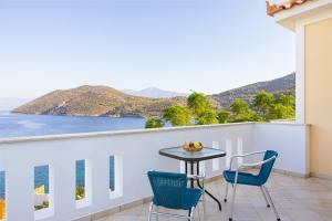 a balcony with a table and chairs and a view at Villa Platanaki in Kerveli