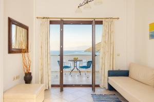 a living room with a view of the ocean at Villa Platanaki in Kerveli
