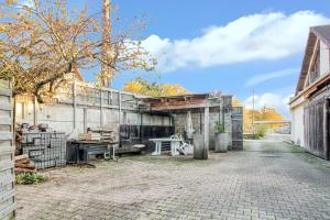 an old building with a table in the middle of a street at Maison accueillante avec jardin proche d'Échenans. in Échenans