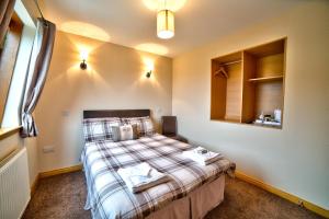 
a bedroom with a bed and a lamp at Kilcumin Guest House in Inverness
