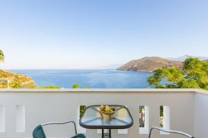 a table on a balcony with a view of the ocean at Villa Platanaki in Kerveli
