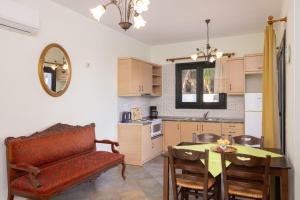 a kitchen and dining room with a table and a couch at Villa Platanaki in Kerveli
