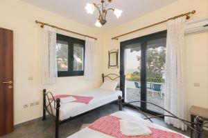 a bedroom with a bed and a window at Villa Platanaki in Kerveli
