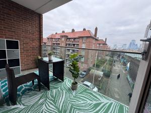 a balcony with a table and a view of a city at Cosy Luxurious Room in The Heart of London in London