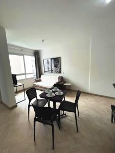 a living room with a table and chairs and a couch at LK Centro 3 in Belo Horizonte