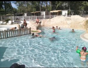 a group of people in a swimming pool at Bungalow confortable à Nans-les-Pins avec piscine partagée in Nans-les-Pins +4 photos