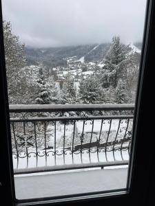 a view from a window of a snow covered mountain at Dom Na Widoku w górach Szczyrk in Szczyrk