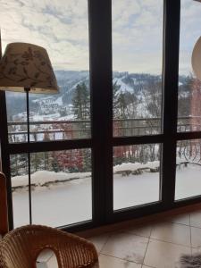 a window with a view of a snow covered mountain at Dom Na Widoku w górach Szczyrk in Szczyrk