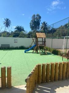 a playground with a swing set on a court at Solar Aruana, Aracaju, Aeroporto, Orla de Atalaia e Praia in Aracaju