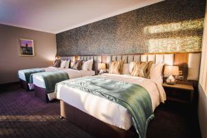 Letto o letti in una camera di Amber Springs Hotel