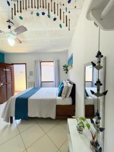 a bedroom with a bed and a mirror at Suites Casa Azul-Vila do Abraão- conforto, limpeza, ótima localização in Abraão