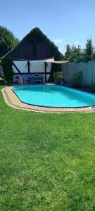 a swimming pool in a yard with a gazebo at Apartment in Fuhlendorf 2747 in Fuhlendorf