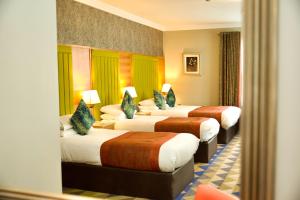 Letto o letti in una camera di Amber Springs Hotel