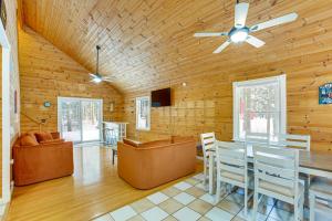 a living room with a ceiling fan and a table and chairs at Less Than 1 Mi to ATV Trails Cadillac Golf Retreat! in Cadillac
