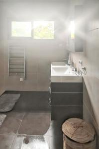 a bathroom with a sink and a toilet at Villa élégante à Beauchêne avec piscine privée in Beauchêne