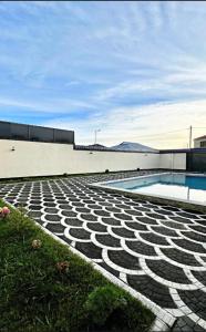 a building with a swimming pool next to a building at Gabala Double Villas in Gabala