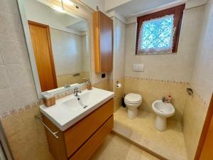 a bathroom with a sink and a toilet and a mirror at Attico Belvedere - metro C e posto auto in Rome +39 photos