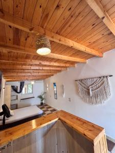 a room with a wooden ceiling and a couch at Mashrum House in Dahab