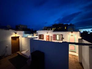 a night view of a white house with lights at Mashrum House in Dahab