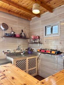 a kitchen with a table and a stove in it at Mashrum House in Dahab +5 photos