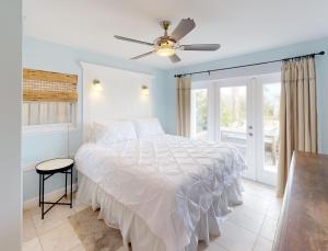 a bedroom with a bed and a ceiling fan at BEST BEACH Cottage Two Gorgeous Ocean Views - Renovated Like POTTERY BARN - Beach Steps Away in Saint Augustine Beach