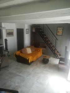 a bedroom with a bed and a staircase at Bord de vilaine in Nivillac