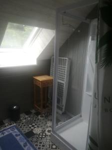 a small bathroom with a small table and a window at Bord de vilaine in Nivillac +2 photos