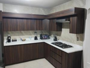 a kitchen with a stove and a counter top at executive home, vacation work in Ramos Arizpe