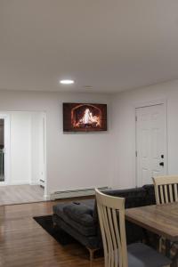 a living room with a fireplace on the wall at Cozy Near Boston with Outdoor Space in Everett