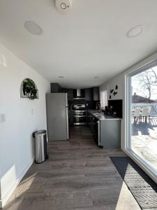 a kitchen with stainless steel appliances and a large window at Cozy Near Boston with Outdoor Space in Everett