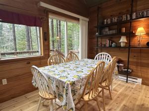 a dining room with a table and chairs at Culps Cascade | Wi-Fi, Woodstove, Cedar Hot tub in Packwood +32 photos