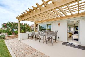 a patio with chairs and a wooden pergola at Cottage Four DIRECT OCEANFRONT Romantic Cottage Best Beach - Walk to Restaurants - Downtown only 5 Miles in Saint Augustine Beach